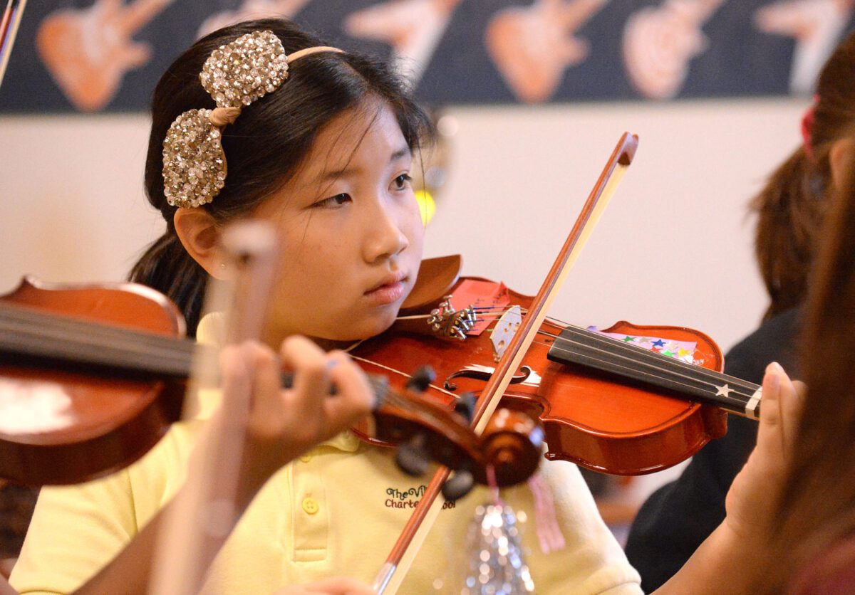 George Horsford / Daily Sun - Sydnie Wu, {cq}, a fourth grade student at the Fourth and Fifth Grade Center of The Villages Charter School, plays her violin during the Buffalo Adventures Violin After School program on December 17, 2014.
