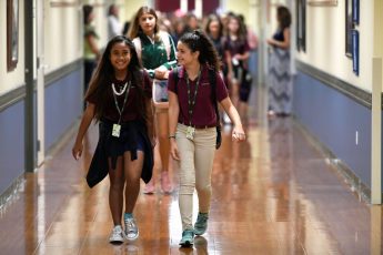 Max Gersh / Daily Sun - Leilani Cummings, left, 11, and Alissa Platt, 11, walk to their classroom on the first day of school Thursday, Aug. 9, 2018, at The Villages Charter Middle School.