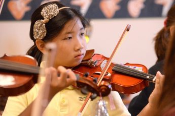 George Horsford / Daily Sun - Sydnie Wu, {cq}, a fourth grade student at the Fourth and Fifth Grade Center of The Villages Charter School, plays her violin during the Buffalo Adventures Violin After School program on December 17, 2014.